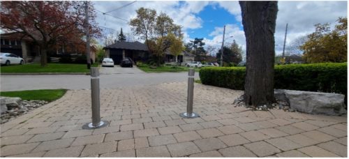 The installed retractable bollards on the driveway